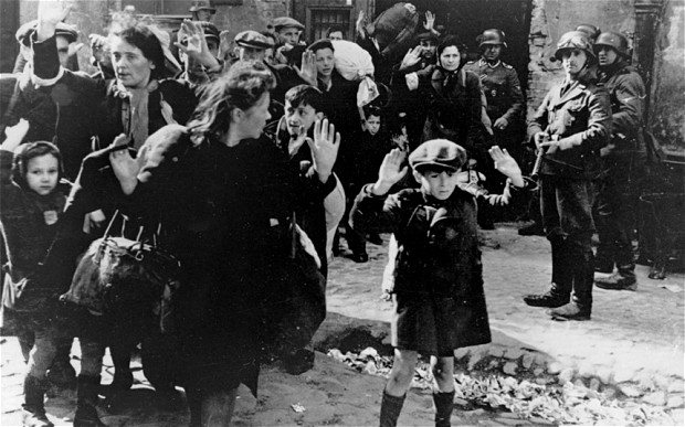 A group of Jews are escorted from the Warsaw Ghetto by German soldiers on April 19, 1943