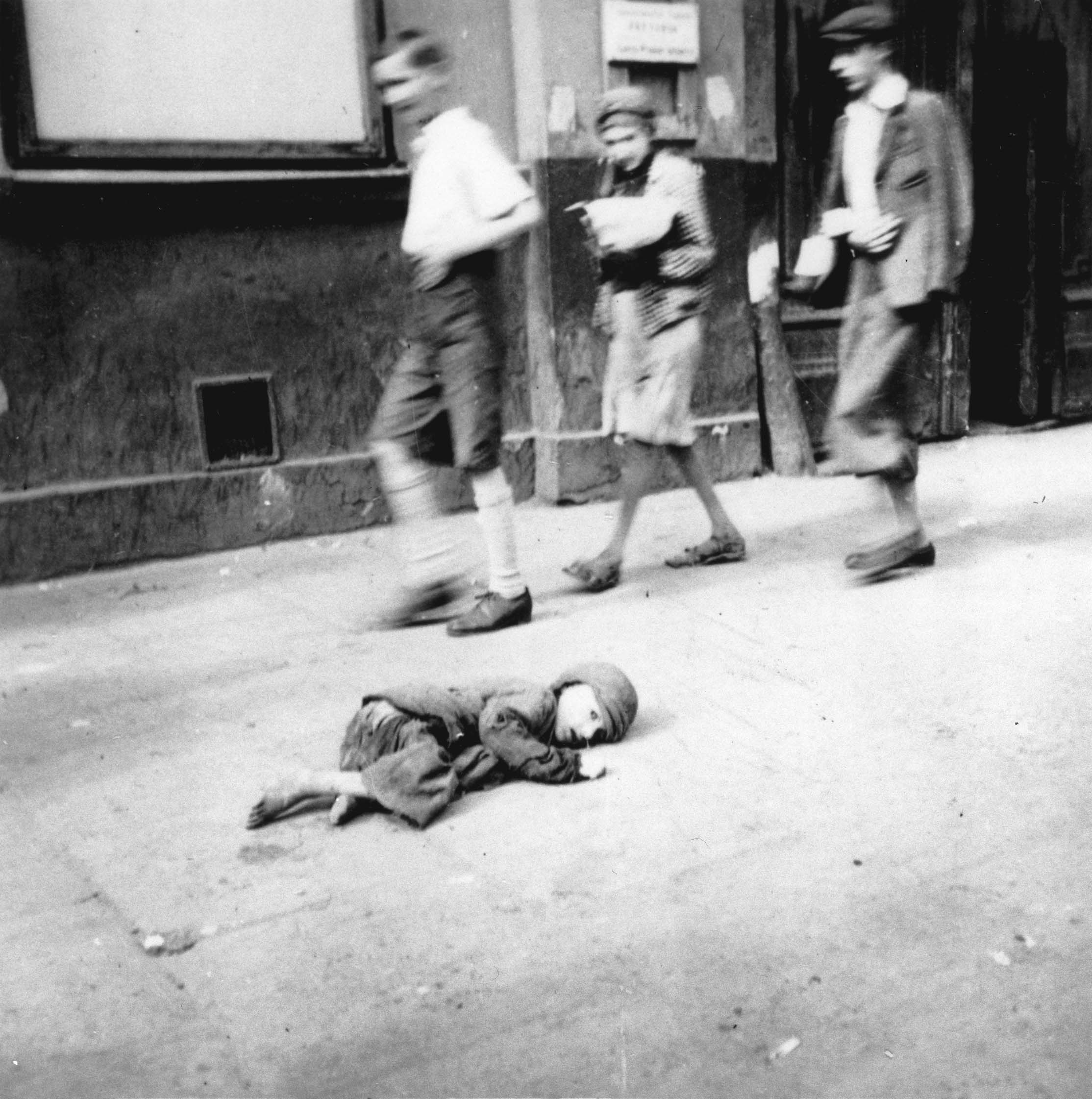 A starving, helpless child lies on the streets of the Warsaw Ghetto, Sep 1941