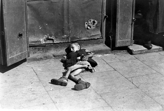 Warsaw ghetto, summer 1941, Poland, A boy lying in the street